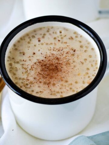 This is a white mug with sago porridge inside.