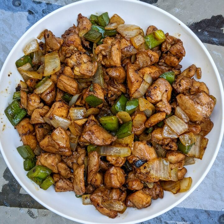 This is a photo of small pieces of black pepper chicken cut up and in a white bowl.