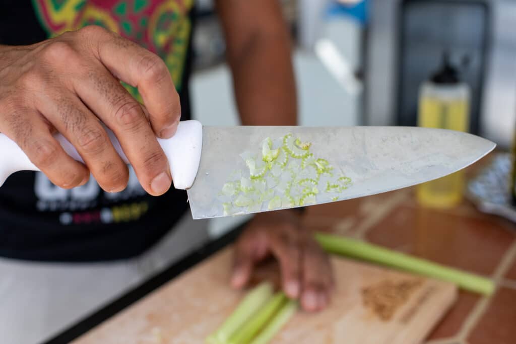 chef Devan Rajkumar showing celery on knife