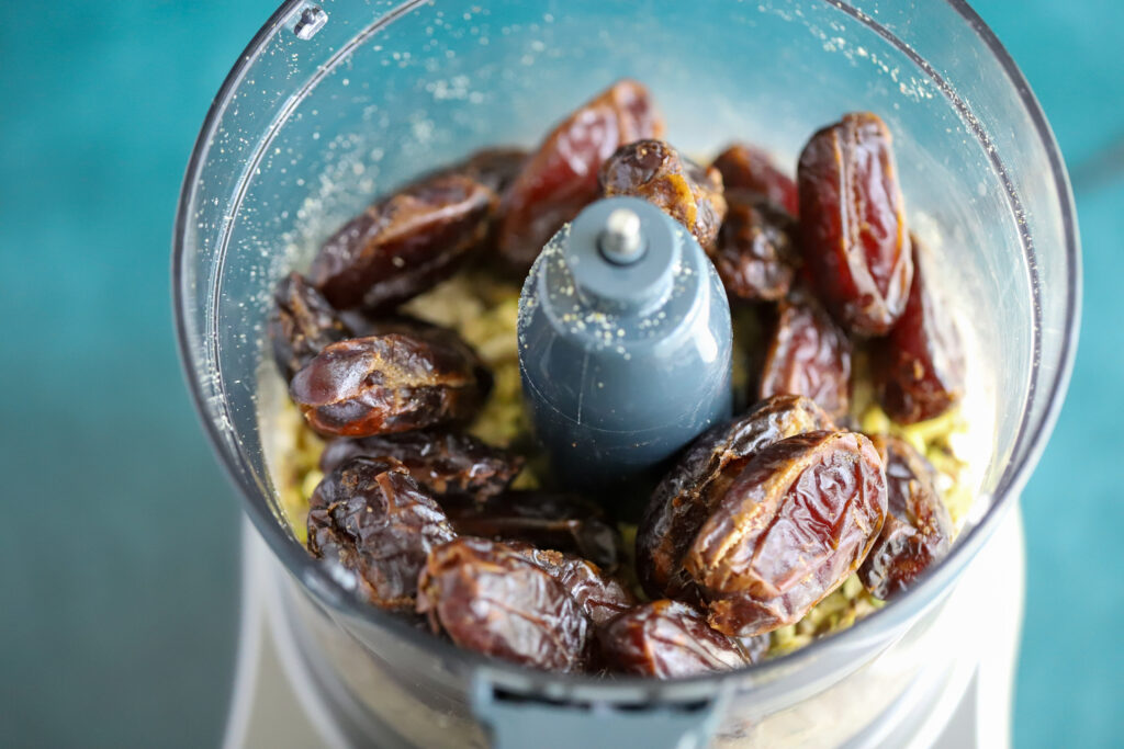 This is a photo of dates in the food processor with pistachios and cashews