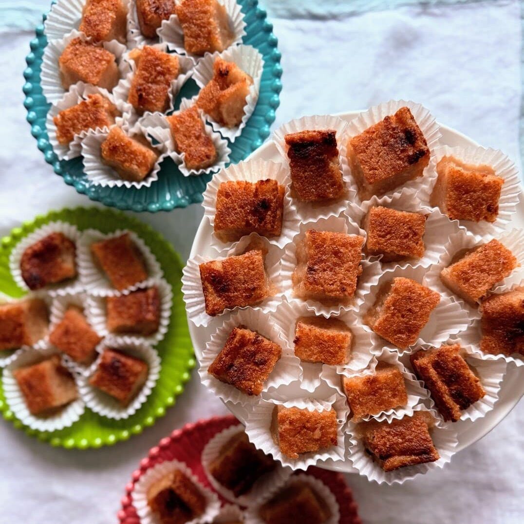 Cassava pone cut into small squares and served in mini cupcake liners