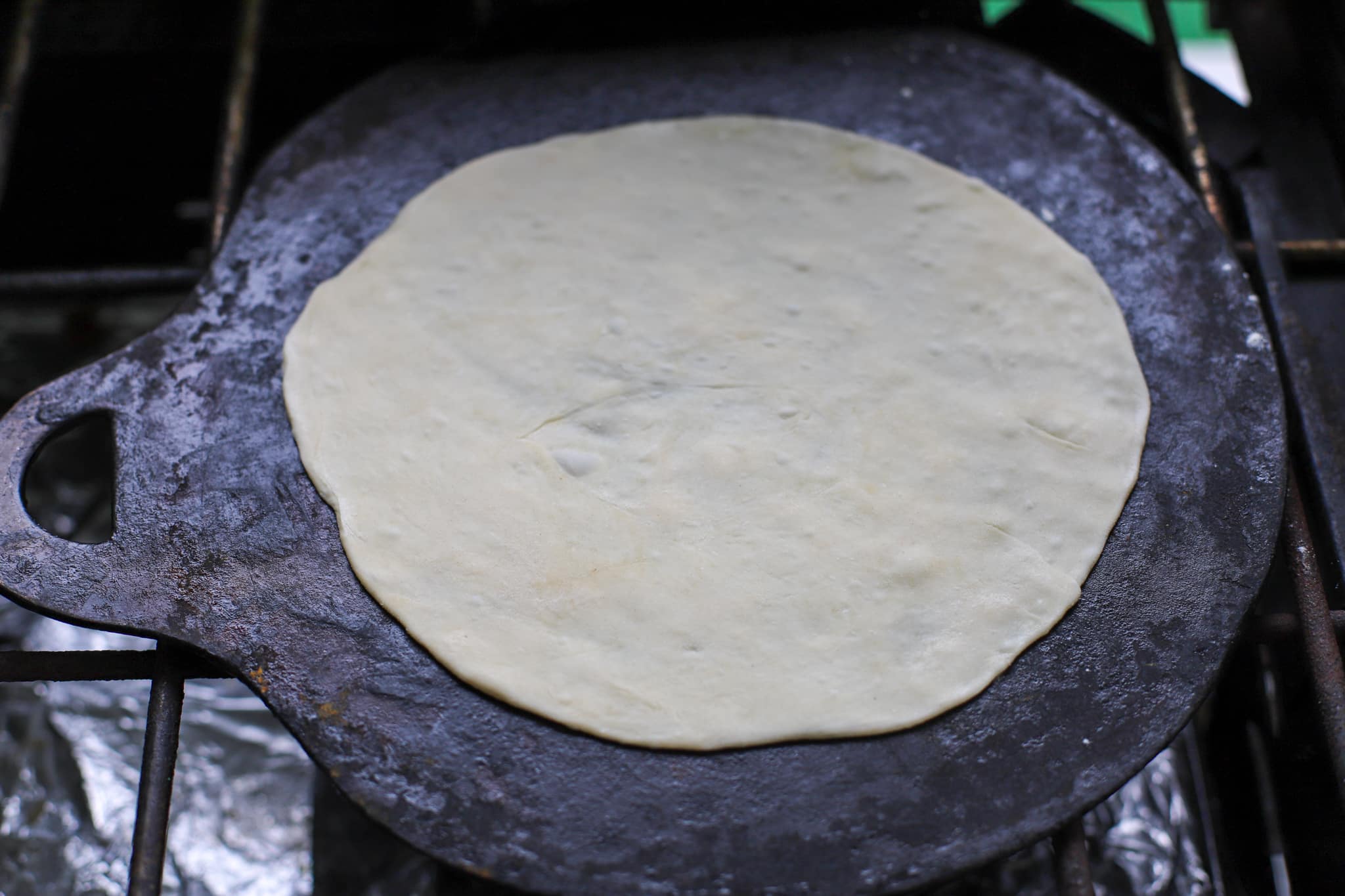cooking the roti on the tawa