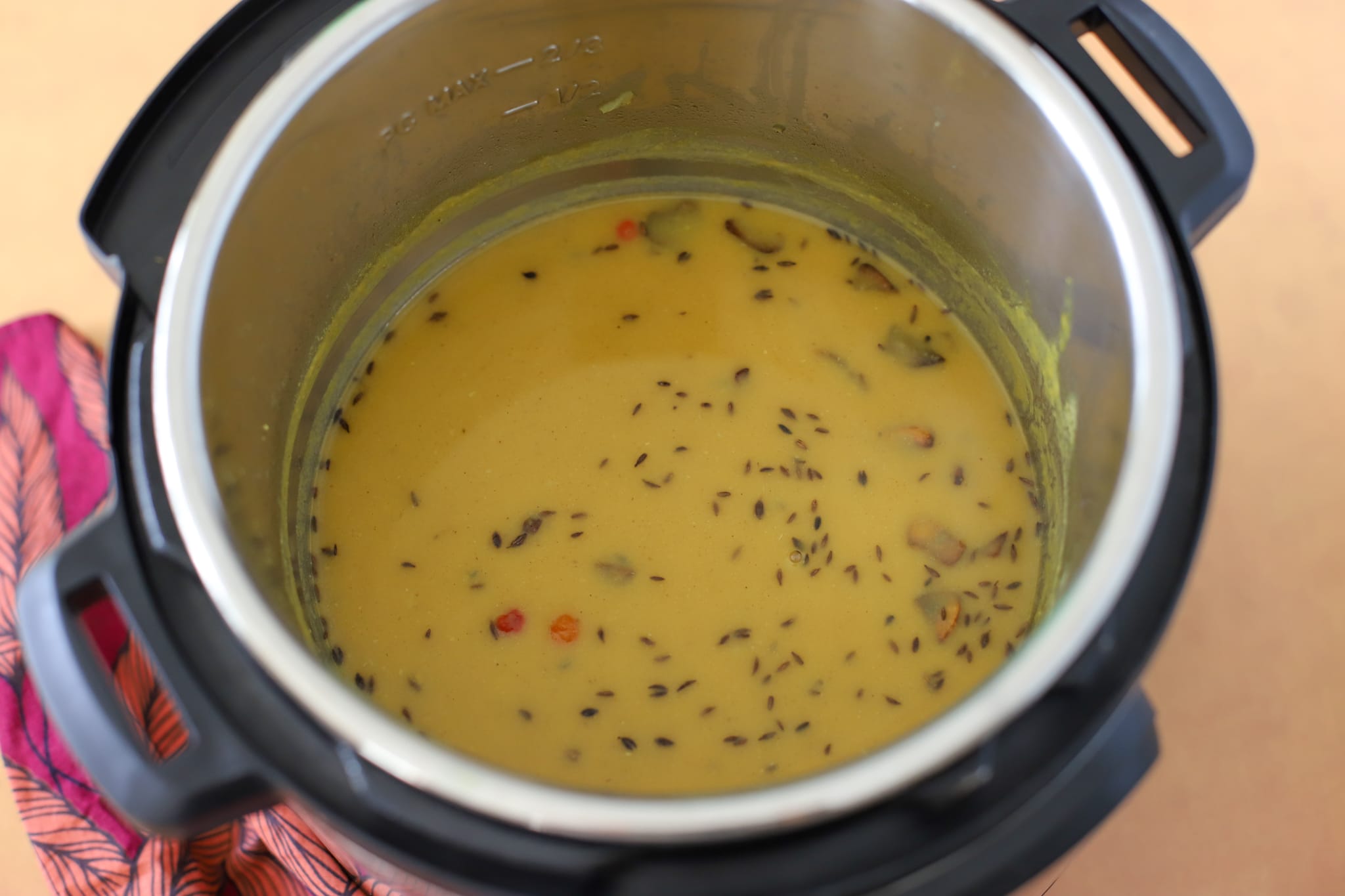 This photo shows Indo-caribbean style dhal in an instant pot after being tempered or chunkay with garlic and geera