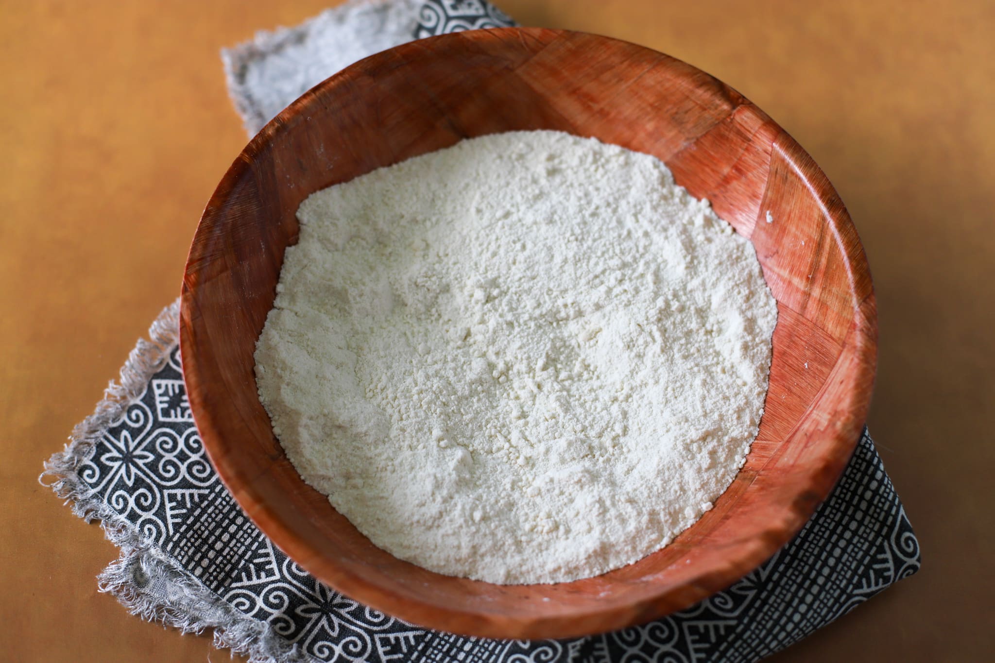 A wooden bamboo bowl with dry flour mixture