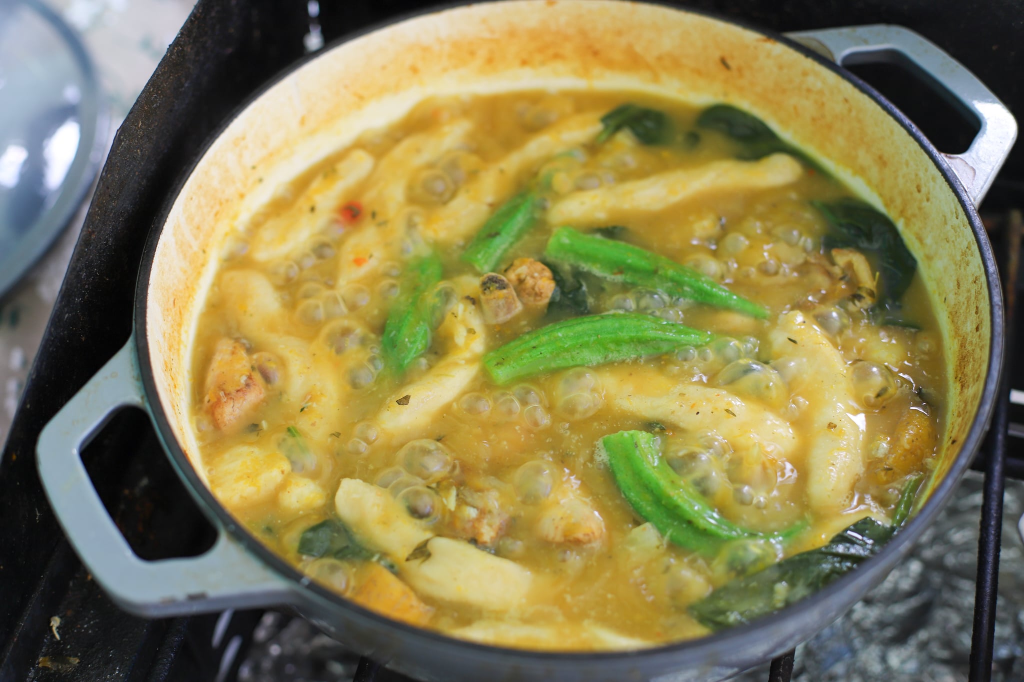 Small batch soup - boiling in pot. The okra and dumpling showing as well as pumpkin and spinach