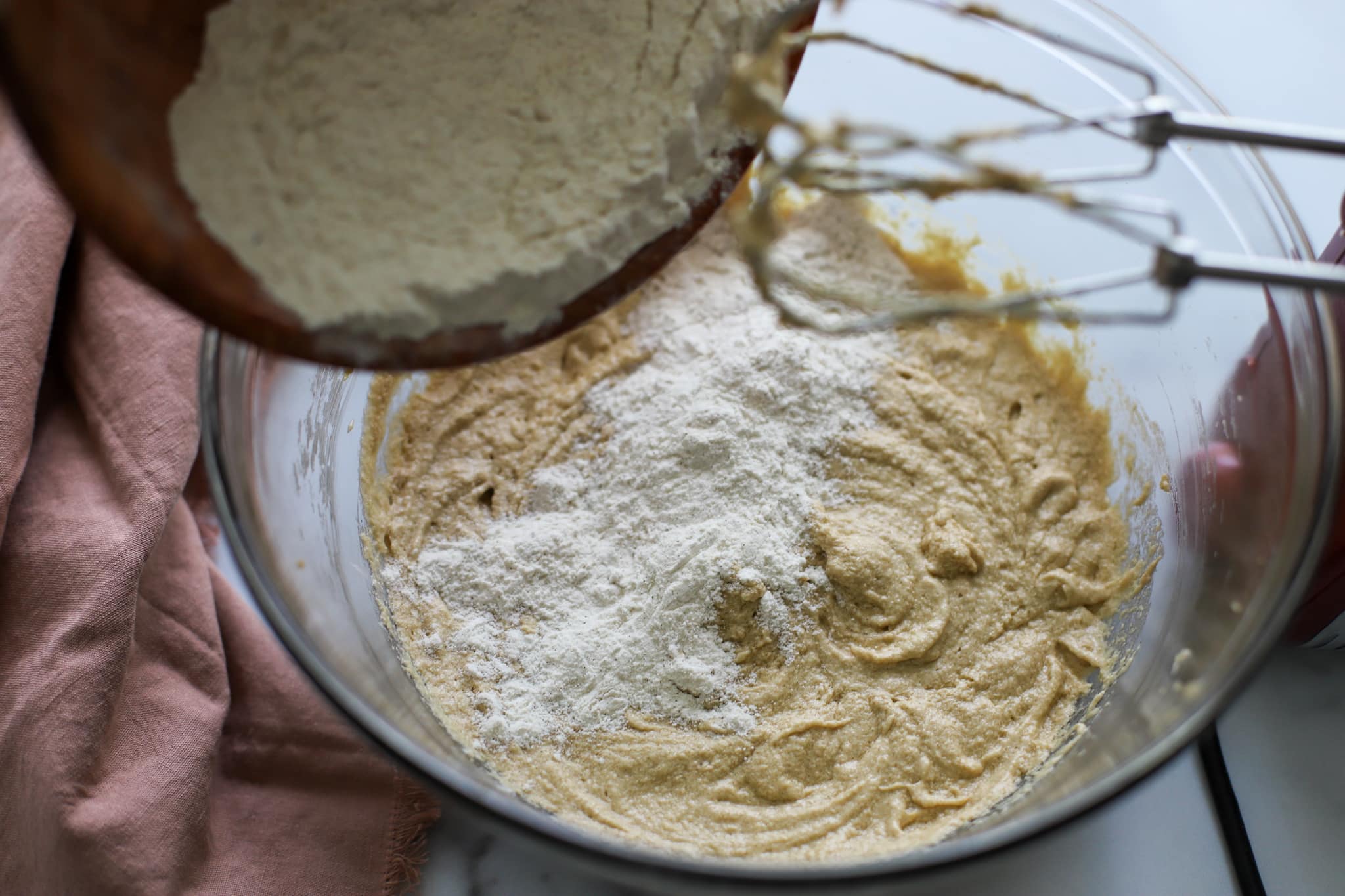 Flour being added to cake batter