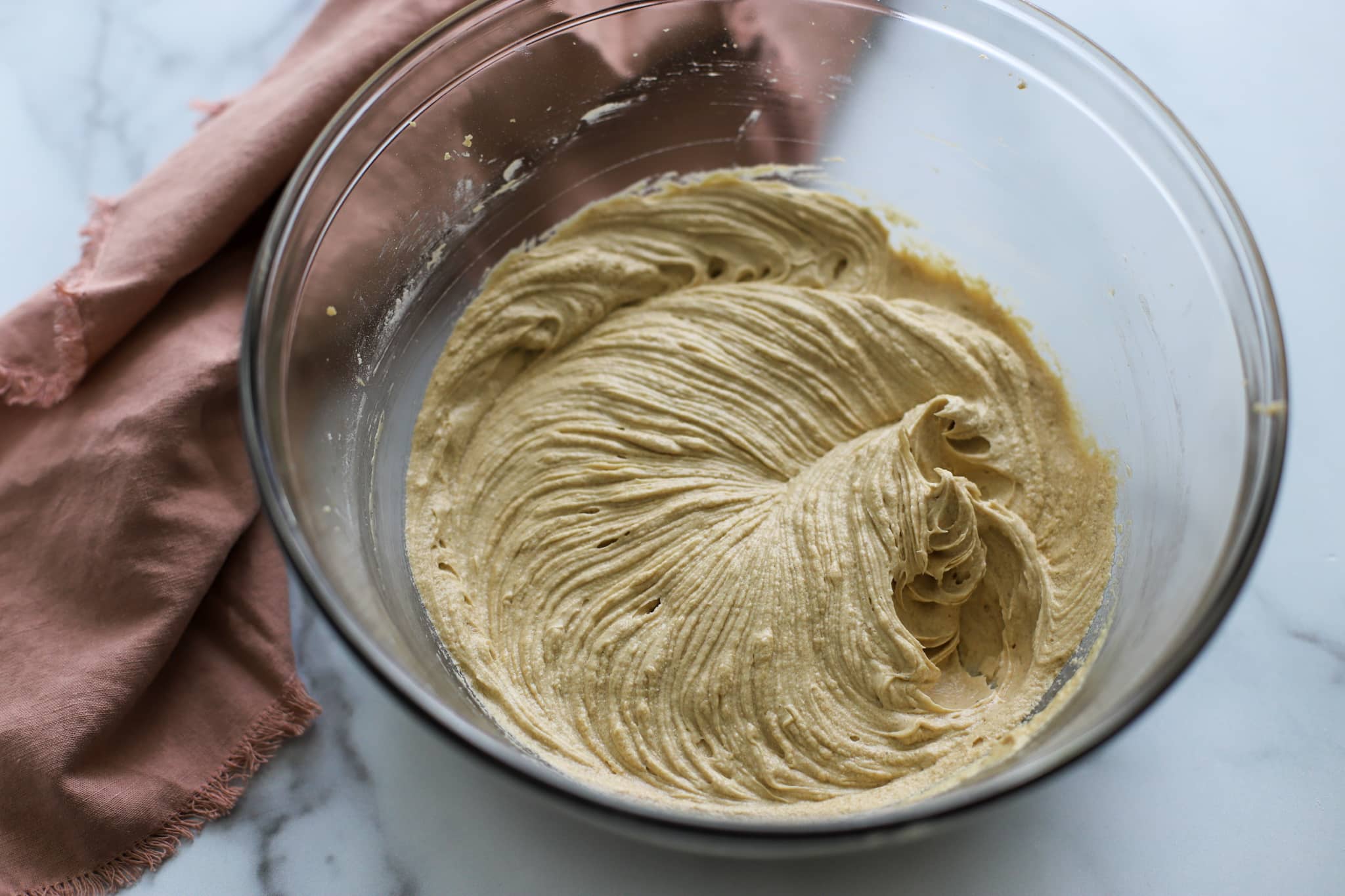Cake batter in mixing bowl shows the texture of the batter