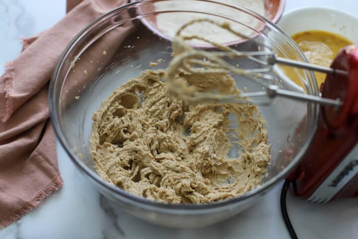 butter and sugar creamed in a clear mixing bowl