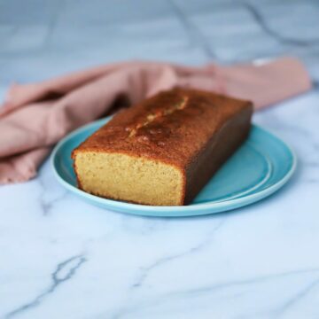 Inside view of West Indian sponge cake in a blue plate near a pink napkin