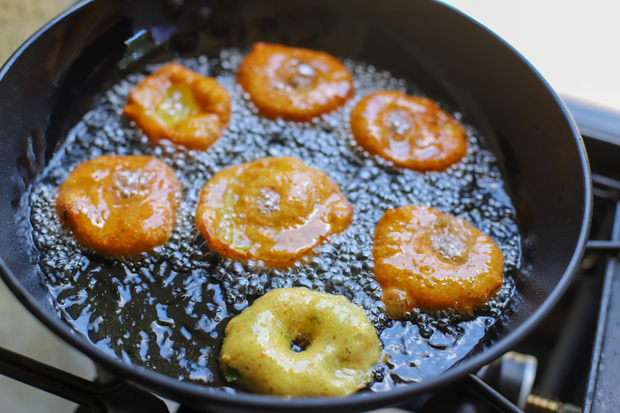 bara frying in black wok with grapeseed oil