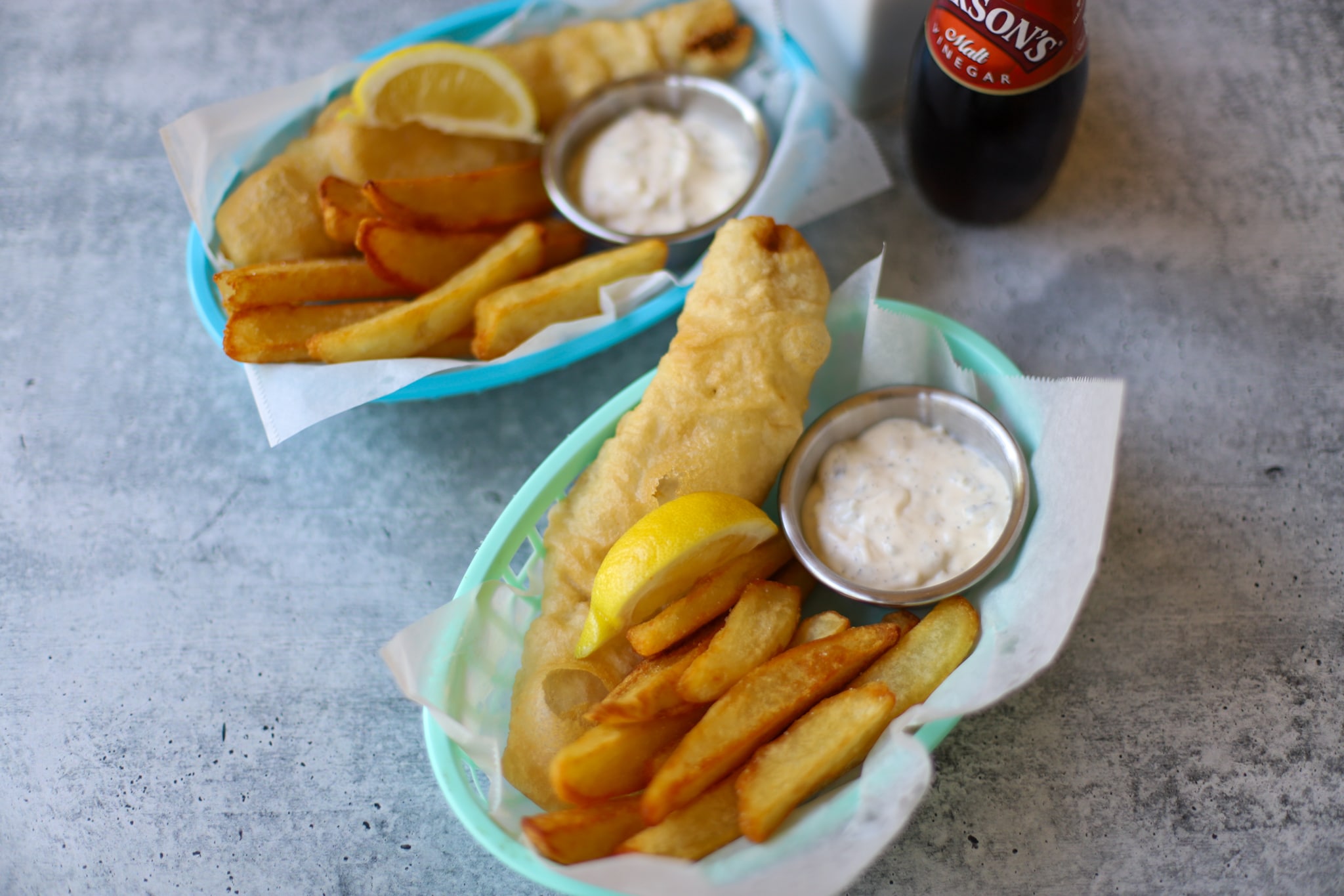 Image of overhead shot of fish and chips in blue baskets landscape sized