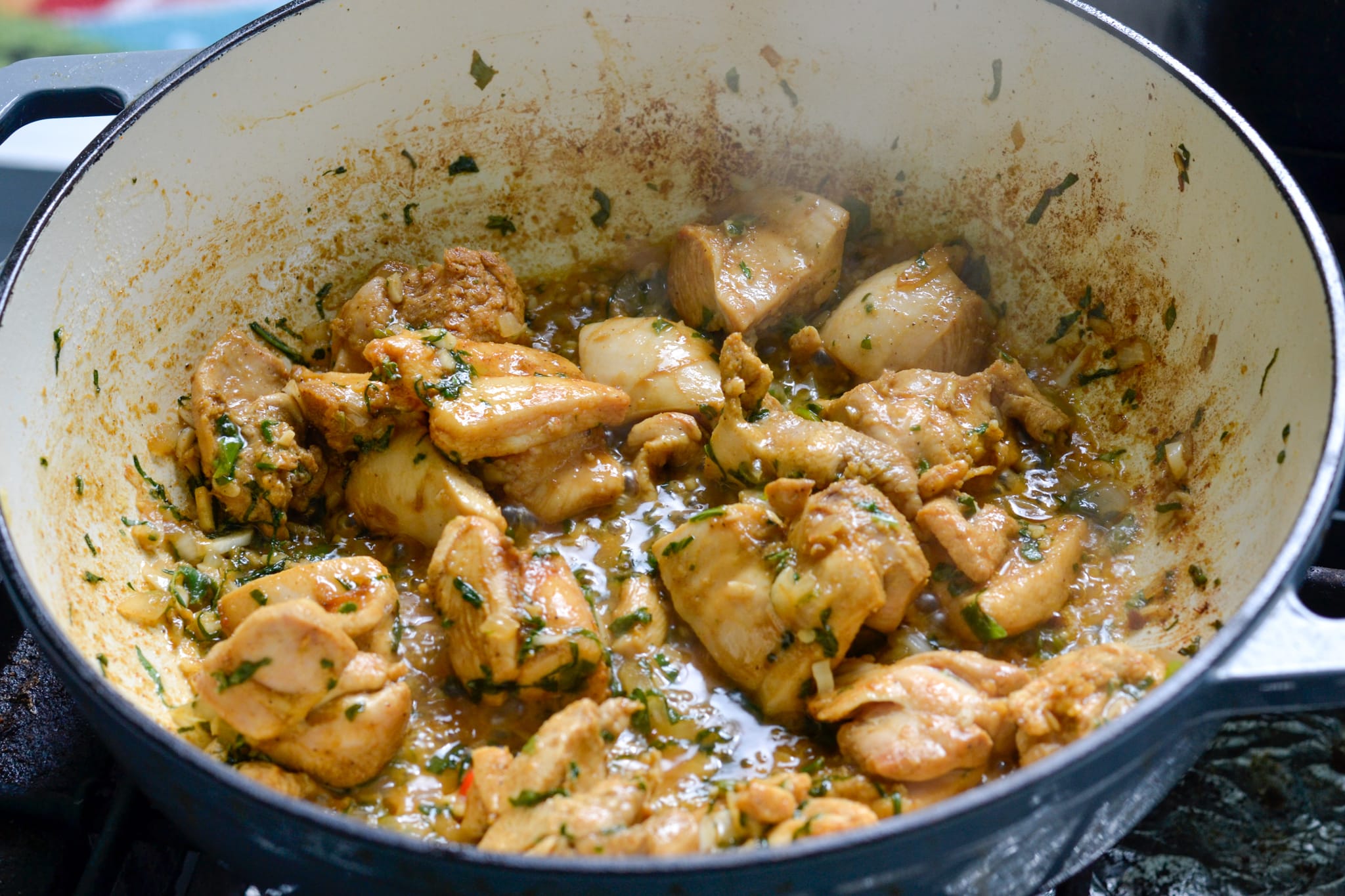 Chicken for Guyanese cookup rice simmering in a pot